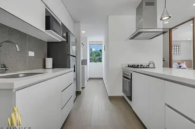 a white kitchen with white counters and a sink at Campestre 704 - Sophisticated Apt with AC & gym in Envigado