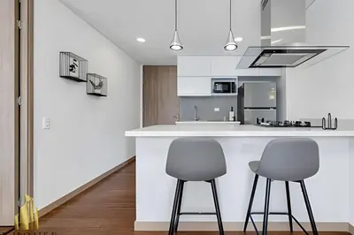 two chairs sitting at a counter in a kitchen at Campestre 704 - Sophisticated Apt with AC & gym in Envigado