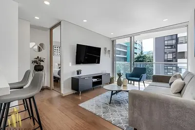a living room with a couch and a tv at Campestre 704 - Sophisticated Apt with AC & gym in Envigado