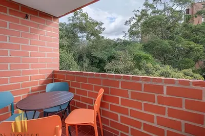 a patio with a table and chairs and a brick wall at Caracolí 301 - Donde el Estilo Grita Libertad in El Poblado