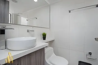 a white bathroom with a sink and a toilet at Caracolí 301 - Donde el Estilo Grita Libertad in El Poblado