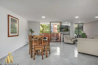 a dining room and living room with a table and chairs at Caracolí 301 - Donde el Estilo Grita Libertad in El Poblado