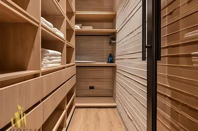 a walk in closet with wooden shelving at Casa Biflora - Natural luxury in top location in El Poblado
