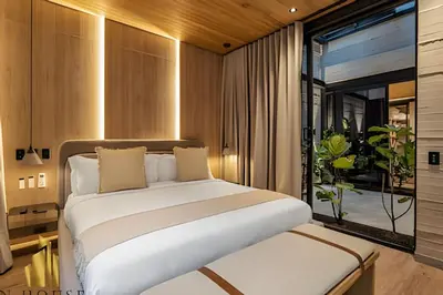 a bedroom with a large white bed and a window at Casa Biflora - Natural luxury in top location in El Poblado