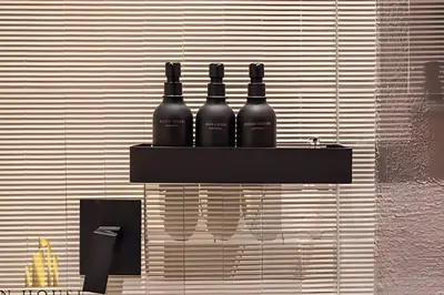 three bottles of wine sitting on a shelf on a wall at Casa Biflora - Natural luxury in top location in El Poblado