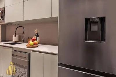 a kitchen with a stainless steel refrigerator and a bowl of fruit at Casa Biflora - Natural luxury in top location in El Poblado
