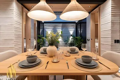 a dining room with a table with chairs and lights at Casa Biflora - Natural luxury in top location in El Poblado