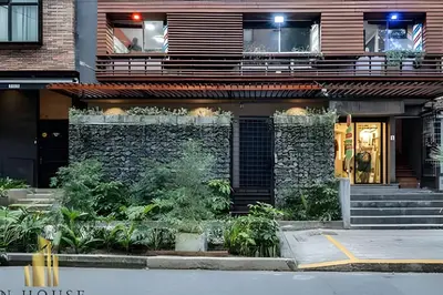 a building with a stone wall and stairs in front of it at Casa Biflora - Natural luxury in top location in El Poblado