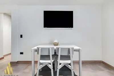 a white table and two white chairs in a room at Casa Solei 12-13 - Prestigious & Priv Apt/Bath Tub in El Poblado