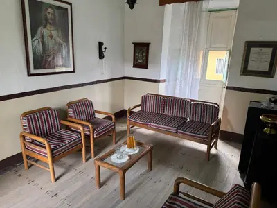 a living room with two chairs and a table at Casa colonial con encanto en Sonsón in Sonsón
