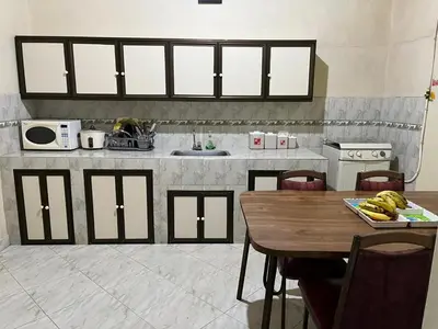 a kitchen with a wooden table and a counter with a sink at Casa colonial con encanto en Sonsón in Sonsón