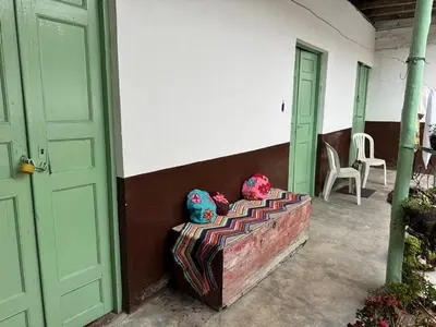 a couch sitting outside of a house with two pillows at Casa colonial con encanto en Sonsón in Sonsón