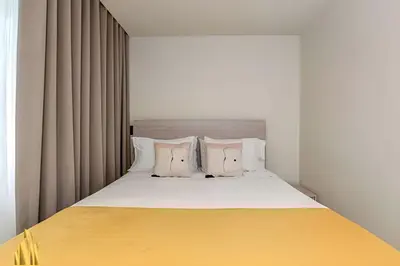 a bedroom with a large bed with two pillows at Casa Solei 12-3 - Prime Location: Enjoy El Poblado in El Poblado