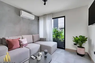 a living room with a couch and a table at Casa Solei 12-7 - Bright & Chic Apt in Manila / AC in El Poblado