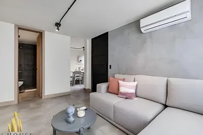 a living room with a couch and a table at Casa Solei 12-7 - Bright & Chic Apt in Manila / AC in El Poblado