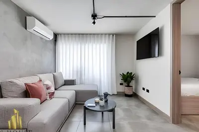 a living room with a couch and a table at Casa Solei 12-7 - Bright & Chic Apt in Manila / AC in El Poblado