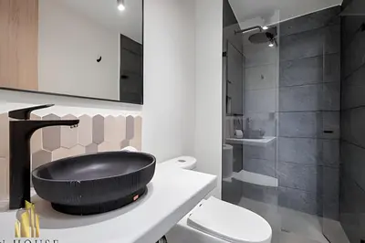 a bathroom with a black sink on a counter at Casa Solei 12-7 - Bright & Chic Apt in Manila / AC in El Poblado