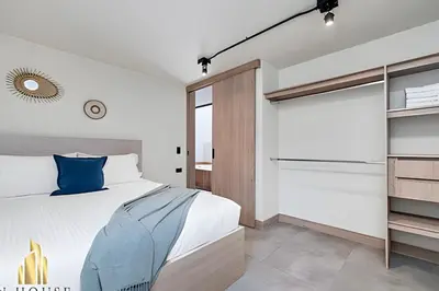 a bedroom with a large bed and a window at Casa Solei 12-9 - Stylish Apt with Jacuzzi & AC in El Poblado