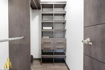 a walk in closet with empty shelves and a door at Class Suites 202 - Colorful with Pool and gym in El Poblado