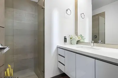 a white bathroom with a sink and a mirror at Class Suites 202 - Colorful with Pool and gym in El Poblado
