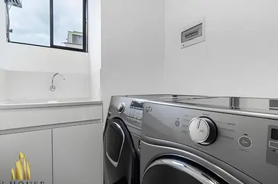 a kitchen with a washing machine and a sink at Class Suites 202 - Colorful with Pool and gym in El Poblado