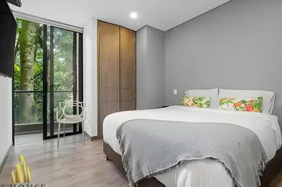 a bedroom with a large bed and a large window at Class Suites 202 - Colorful with Pool and gym in El Poblado