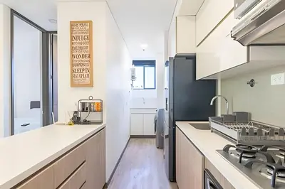 a kitchen with white cabinets and a counter top at Class Suites 502 - Modern Tranquility/Priv Balcony in El Poblado