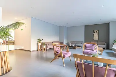 a living room with purple chairs and a table at Class Suites 502 - Modern Tranquility/Priv Balcony in El Poblado