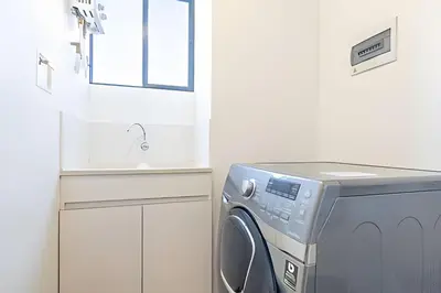 a washing machine in a kitchen with a sink at Class Suites 502 - Modern Tranquility/Priv Balcony in El Poblado