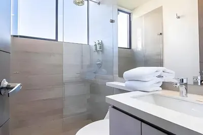 a bathroom with a toilet and a sink and a shower at Class Suites 503 - Bright & Minimalistic Apt/Pool in El Poblado