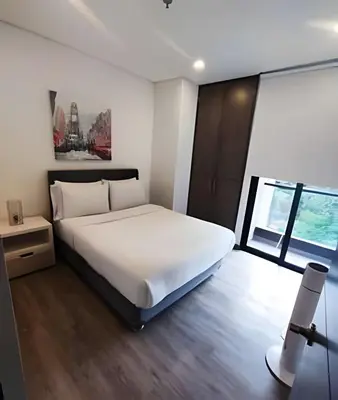a bedroom with a large white bed and a window at Class Suites 503 - Bright & Minimalistic Apt/Pool in El Poblado