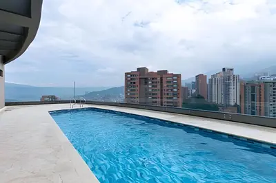 a swimming pool on the roof of a building at Class Suites 503 - Bright & Minimalistic Apt/Pool in El Poblado