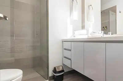 a bathroom with a sink and a toilet and a shower at Class Suites 503 - Bright & Minimalistic Apt/Pool in El Poblado