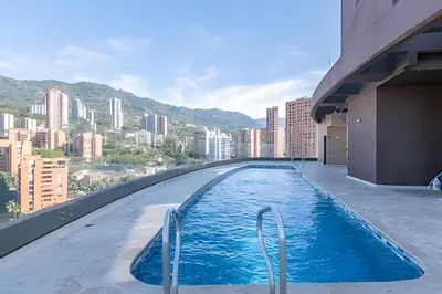 a swimming pool on top of a building with a city at Class Suites 503 - Bright & Minimalistic Apt/Pool in El Poblado