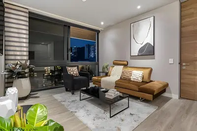a living room with a couch and a tv at Energy 1603 - Modern Design & Prime Location/ AC in El Poblado