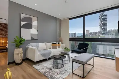 a living room with a couch and a table at Energy 403 - Prestigious Urban Oasis / Pool in El Poblado