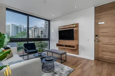 a living room with a couch and a tv at Energy 403 - Prestigious Urban Oasis / Pool in El Poblado