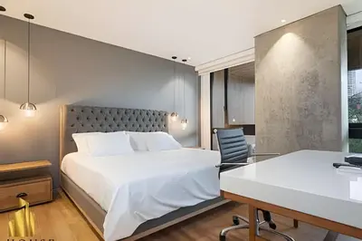a bedroom with a large white bed and a desk at Energy 601 - Prestigious Apt/Pool & Jacuzzi in El Poblado