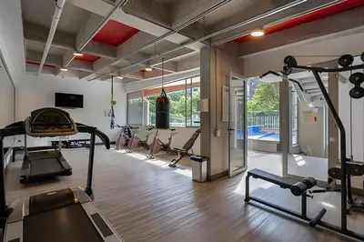 a gym with several treadmills and machines in a room at Finito 1512 - Modern Apt with Views & Balcony in El Poblado