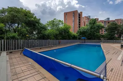 a large swimming pool with a fence and trees at Finito 1512 - Modern Apt with Views & Balcony in El Poblado