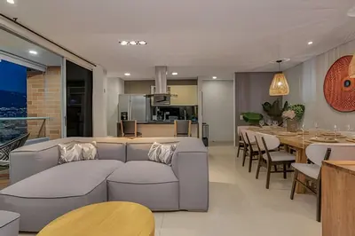 a living room with a couch and a dining room at Finito 1512 - Modern Apt with Views & Balcony in El Poblado