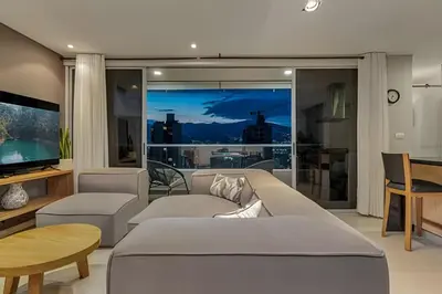 a living room with a couch and a television at Finito 1512 - Modern Apt with Views & Balcony in El Poblado
