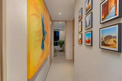 a hallway with art on the walls at Finito 1512 - Modern Apt with Views & Balcony in El Poblado
