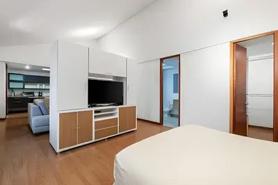 a bedroom with a bed and a flat screen tv at Gauss 1205-Serenity Modern Apt/Terrace/Squash/Gym in El Poblado
