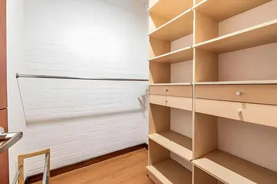 a walk in closet with wooden shelves at Gauss 1205-Serenity Modern Apt/Terrace/Squash/Gym in El Poblado