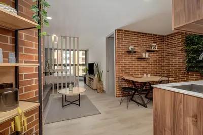 a kitchen and dining room with a brick wall at Kyux 405 - The Icon of Exclusivity in Laureles in Alpujarra