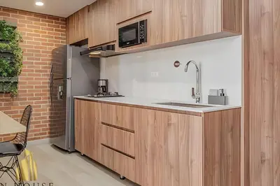 a kitchen with a sink and a refrigerator at Kyux 405 - The Icon of Exclusivity in Laureles in Alpujarra
