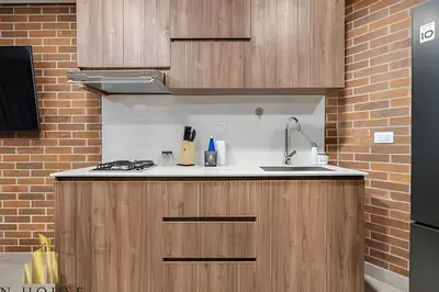 a kitchen with a sink and a brick wall at Kyux 408 - The hidden gem of Laureles in Alpujarra