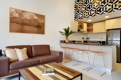 a living room with a couch and a kitchen at La 70 Laureles 302 - Fresh & Well Apt/Priv balcony in Guayaquil