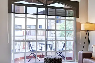 a room with a large window with a table outside at La 70 Laureles 302 - Fresh & Well Apt/Priv balcony in Guayaquil